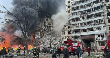 Ukrainian rescuers working at the site of a residential building hit by shelling in Dnipro, southeastern Ukraine on January 14