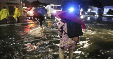 Photos show hundreds of residents have been displaced across the city with the rain set to continue through to the end of the week (pictured, residents in floodwater)