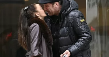 David Seaman and wife Frankie pack on the PDA as they share a kiss outside Manchester hotel