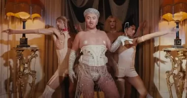 Sam Smith is seen wearing a corset, suspenders and nipple tassels in their new music video for I