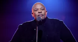 Dr. Dre, who has been famous since the late 1980s, standing at a podium