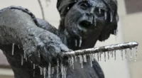 The arctic blast that devastated Texas is moving north that, coupled with a cold front from Canada, could cause record low temperatures in the Northeast and New England. Pictured: Icicles hang from the Angelina Eberly statue in downtown Austin, Texas