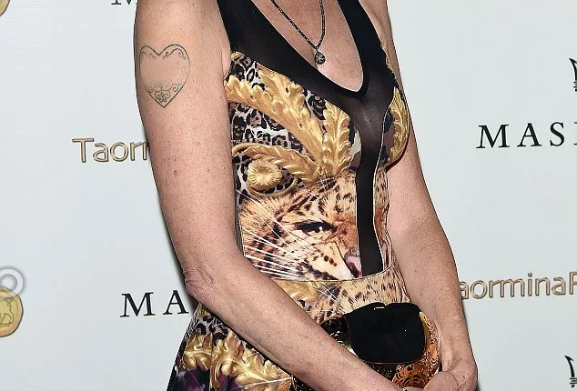 Making a statement: Melanie Griffith appeared to have covered up Antonio Banderas' first name on her heart tattoo as she hit the red carpet of the Taormina Film Festival in Italy on Tuesday