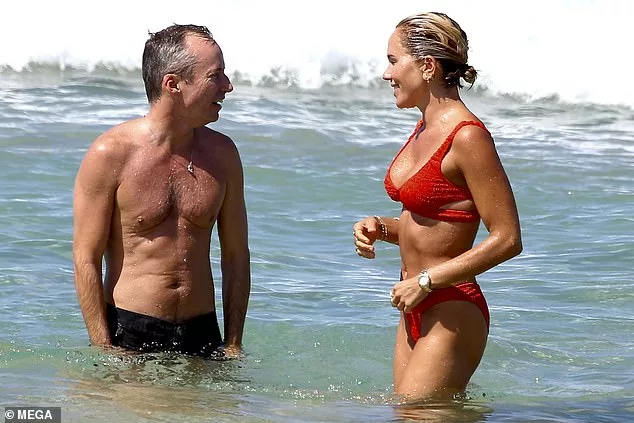 Pip Edwards shows off her bikini body on Bondi beach as she splashes in the sea with her male friend
