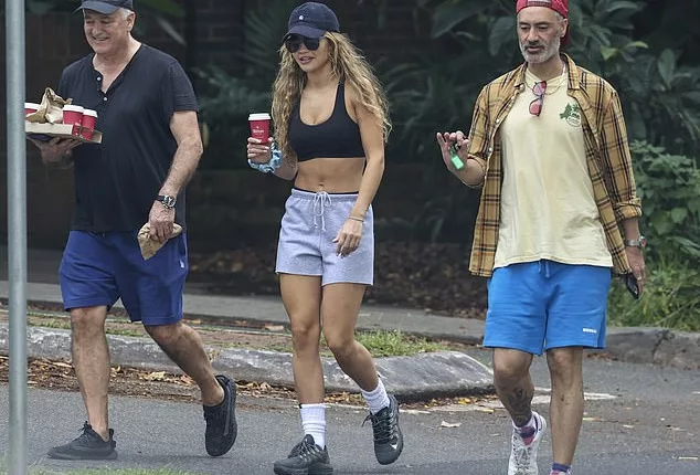 Rita Ora (centre) went for a morning stroll with her husband Taika Waititi (right) and her father Besnik Sahatçiu (left) in Sydney on Tuesday