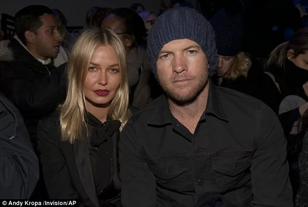 Serious about their fashion: Lara Bingle and Sam Worthington could barely raise a smile as they attended the 2014 Fall/Winter Alexander Wang Fashion show in New York on Saturday