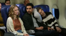 Caitlin Thompson as Taylor and Suraj Sharma as Sid sit next to one another on a plane in
