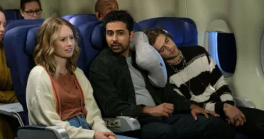 Caitlin Thompson as Taylor and Suraj Sharma as Sid sit next to one another on a plane in