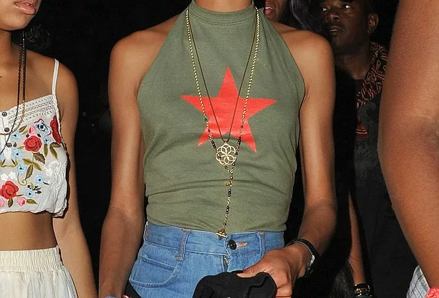 Fashion forward: Willow Smith picked an army green vest top with a red star on it, which she teamed with jean shorts, and casual basketball shoes for her last night at Coachella