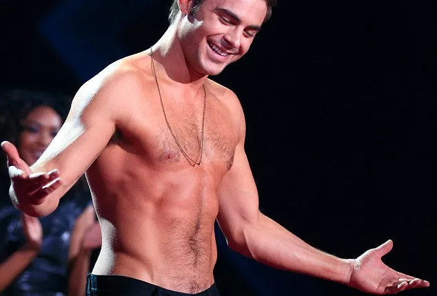 Zac l'orange: Efron's pale face did not match his tangerine torso at the MTV Movie Awards on Sunday