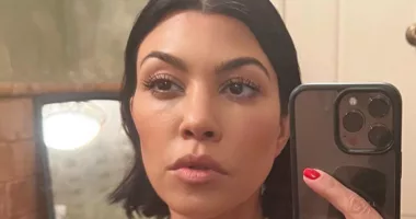 Kourtney Kardashian flaunts cleavage in lace lingerie top and makes out with husband Travis Barker during tour