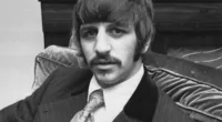 Beatles drummer Ringo Starr wearing a pinstriped suit and sporting a mustache while sitting in an easy chair in 1967.