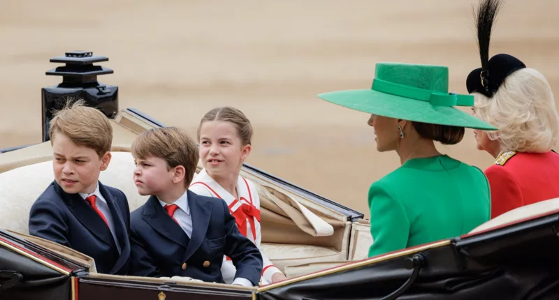 Prince George, Prince Louis, and Princess Charlotte looking back while riding in a carriage with Kate Middleton and Camilla Parker Bowles