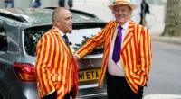 Two MCC members chat as they queue to get into the second Ashes test