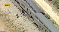 Multiple Amtrak train cars derailed Wednesday afternoon in Southern California , leaving passengers briefly stranded and at least one person injured