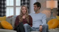 Jill Duggar Dillard and Derick Dillard sitting on a couch in Prime Video docuseries 'Shiny Happy People: Duggar Family Secrets'