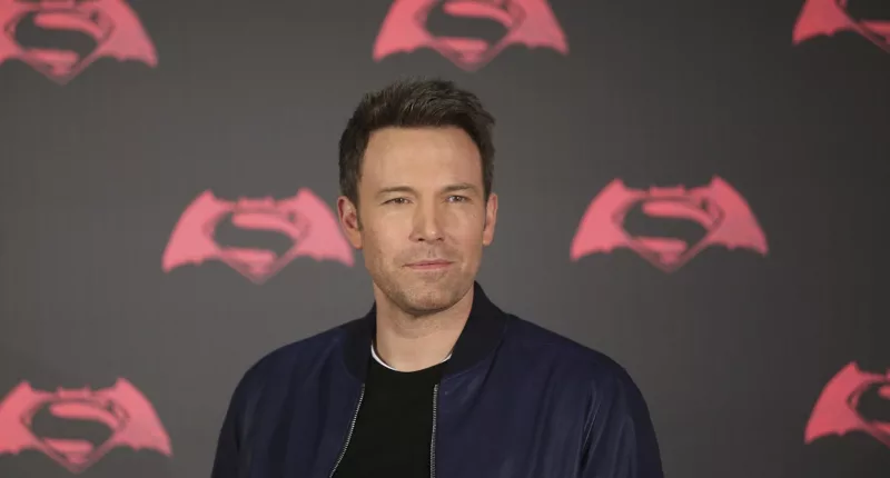 Ben Affleck posing in a black jacket at a photocall for 'Batman v Superman: Dawn of Justice'.