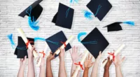 Group of Hands Holding Diplomas and Throwing Graduation Hats