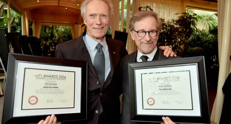 Clint Eastwood and Steven Spielberg posing with awards at the 15th Annual AFI Awards.