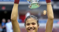 Emma Raducanu of Great Britain celebrates with the championship trophy after defeating Leylah Annie Fernandez of Canada during their Women