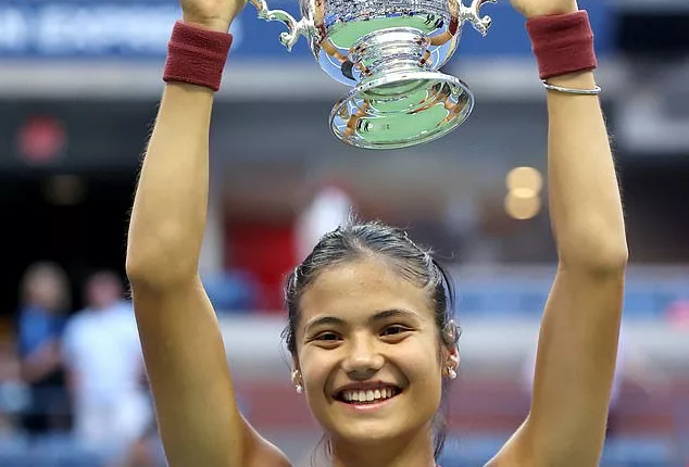 Emma Raducanu of Great Britain celebrates with the championship trophy after defeating Leylah Annie Fernandez of Canada during their Women