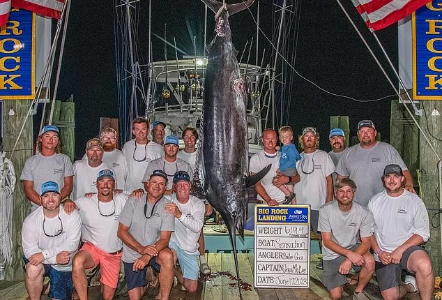 The crew of Sensation and their 619-pound blue marlin was pictured with their catch before they were disqualified from the tournament after it was noticed the fish had been mutilated