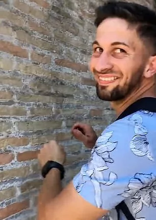 A bystander filmed the tourist as carved the name into the stone walls of the 1,937-year-old building using a set of keys