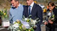 NSW Premier Chris Minns leaves flowers at the site of the crash. A fundraiser has seen more than $242,000 in donations