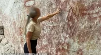 A woman has been fined $431 for touching ancient indigenous rock art in Queensland