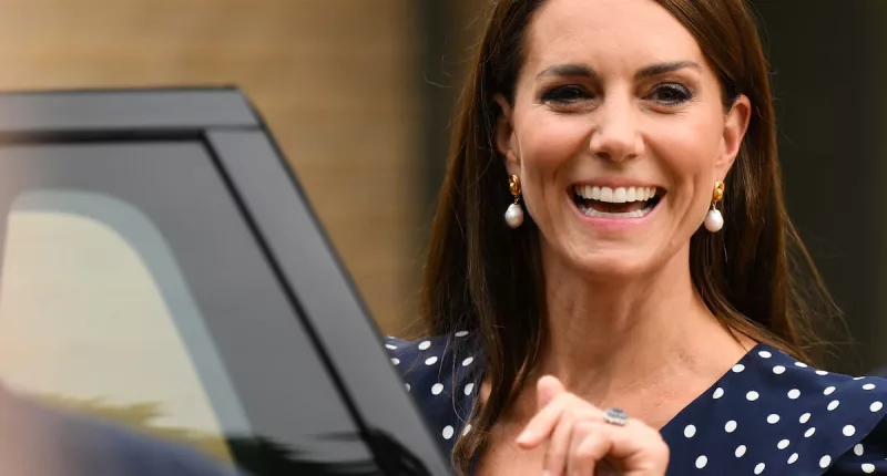 Kate Middleton, whose clothes have gone from 'businesslike' to more 'feminine' in 2023, smiles