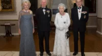King Charles III, whose childhood drawings of Queen Elizabeth and Prince Philip are being auctioned, stands with Queen Camilla and his parents