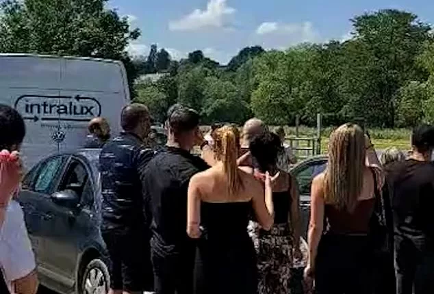 Friends and family of David Baerten appeared to be in disbelief as they looked up to the sky, witnessing his arrival to his own funeral