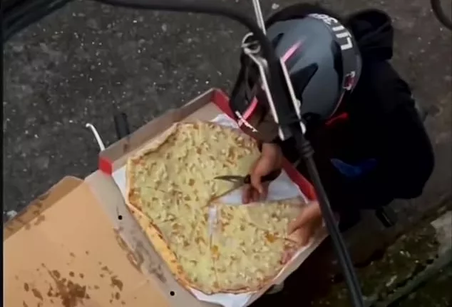 This is the moment a deliveryman was caught tucking into a customer