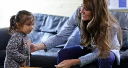 The Princess of Wales, a mother-of-three, visited the Windsor Family Hub this morning where she made some new pals during playtime. Pictured: Kate, 41, doting over a young girl whose family is supported by the centre