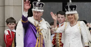 King Charles III and Queen Camilla wave to the crowds from the balcony of Buckingham Palace after their Coronation on May 6