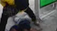 A security guard stands over a man on a St. Louis train station platform. The guard was punching the man who, according to eyewitnesses, had been causing a scene