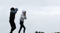 Australians across the country have been told to brace for icy and wet weather this weekend as winter temperatures continue to plummet (pictured, wet weather in Bondi, Sydney)