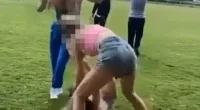 Two teenage girls have been arrested on suspicion of actual bodily harm after footage emerged of a female victim being repeatedly kicked and punched in a park
