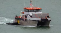 Border Force officials escort 50 migrants into Dover Docks, Kent in January earlier this year