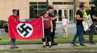 Around a dozen protesters stood outside a synagogue in Marietta, Georgia, on Saturday evening