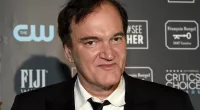 Quentin Tarantino posing in a suit at the Critics' Choice Awards.