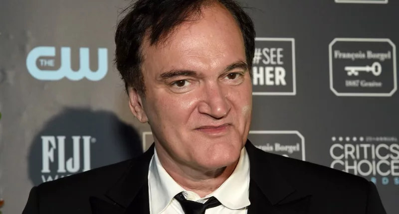 Quentin Tarantino posing in a suit at the Critics' Choice Awards.