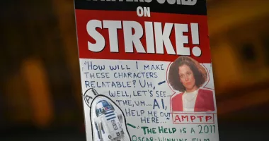 A strike sign is seen on the Hollywood writers picket line outside Universal Studios Hollywood in Los Angeles, California, June 30, 2023. Hollywood's summer of discontent could dramatically escalate this weekend, with actors ready to join writers in a massive "double strike" that would bring nearly all US film and television productions to a halt. The Screen Actors Guild (SAG-AFTRA) is locked in last-minute negotiations with the likes of Netflix and Disney, with the deadline fast approaching at midnight Friday (0700 GMT Saturday). (Photo by Robyn Beck / AFP) (Photo by ROBYN BECK/AFP via Getty Images)