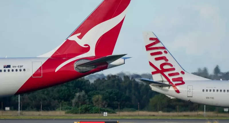Qantas and Virgin Australia planes on the tarmac at an airport.