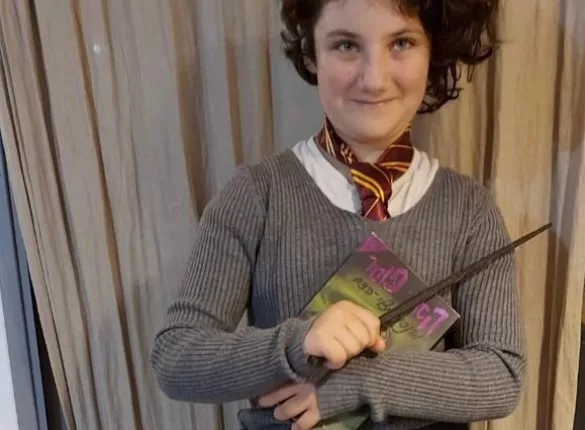 Harry Potter fan Noya Dan, 12, with Harry Potter wand and book
