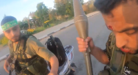 The two Hamas terrorists can be seen stalking through an Israeli community with assault rifles and grenades