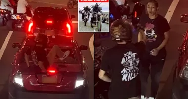Dirt bike-riding goon jumps on car with kids smashing back windshield