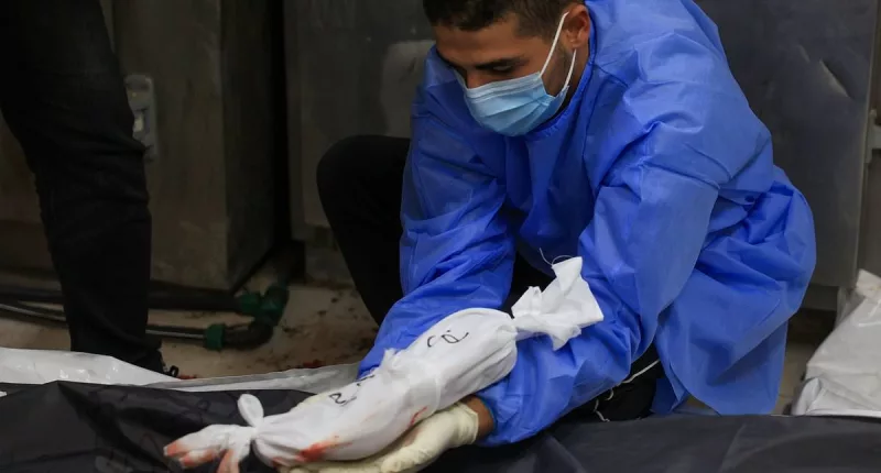 Doctor places body of an unborn child with its mother who died in Gaza