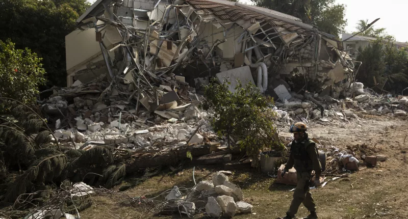 Rescue crews search for bodies after the Hamas attack on the Kibbutz in Be’eri