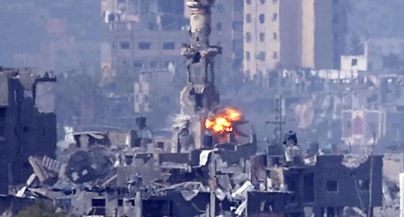As a missile strikes behind a minaret in Gaza, the Israeli Defence Forces has said it has eliminated two senior Hamas terror chiefs